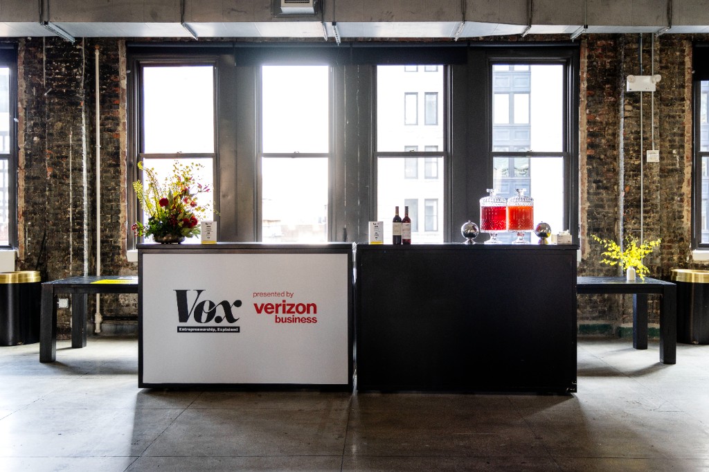 Branded Vox and Verizon Business reception setup before the panel